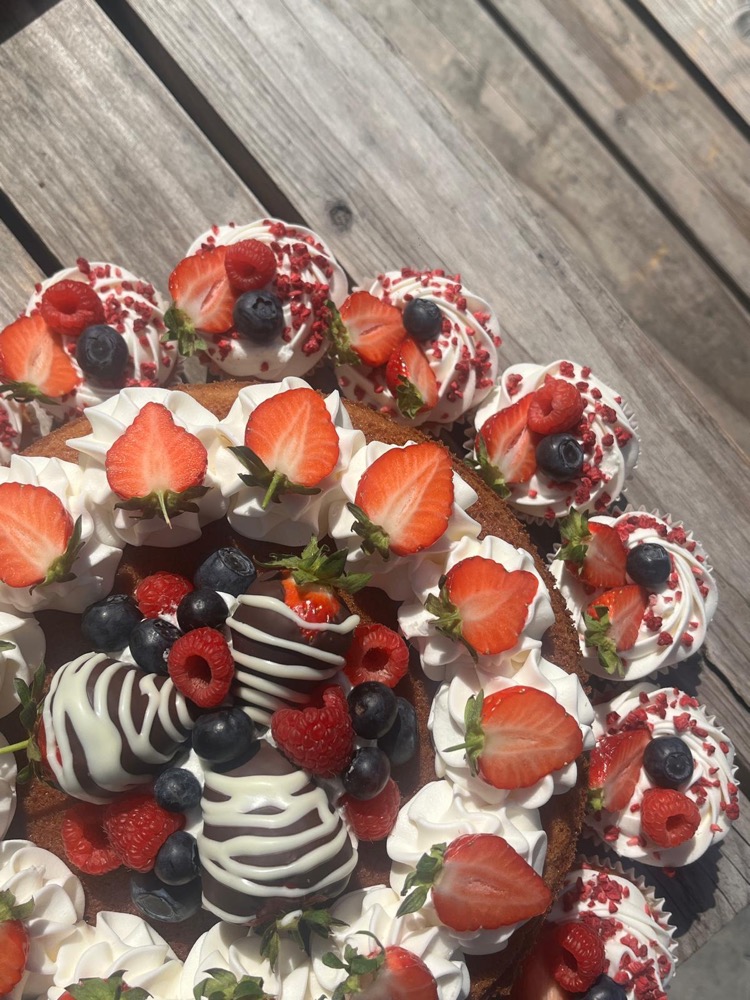 Cake topped with cream swirls and fresh strawberries